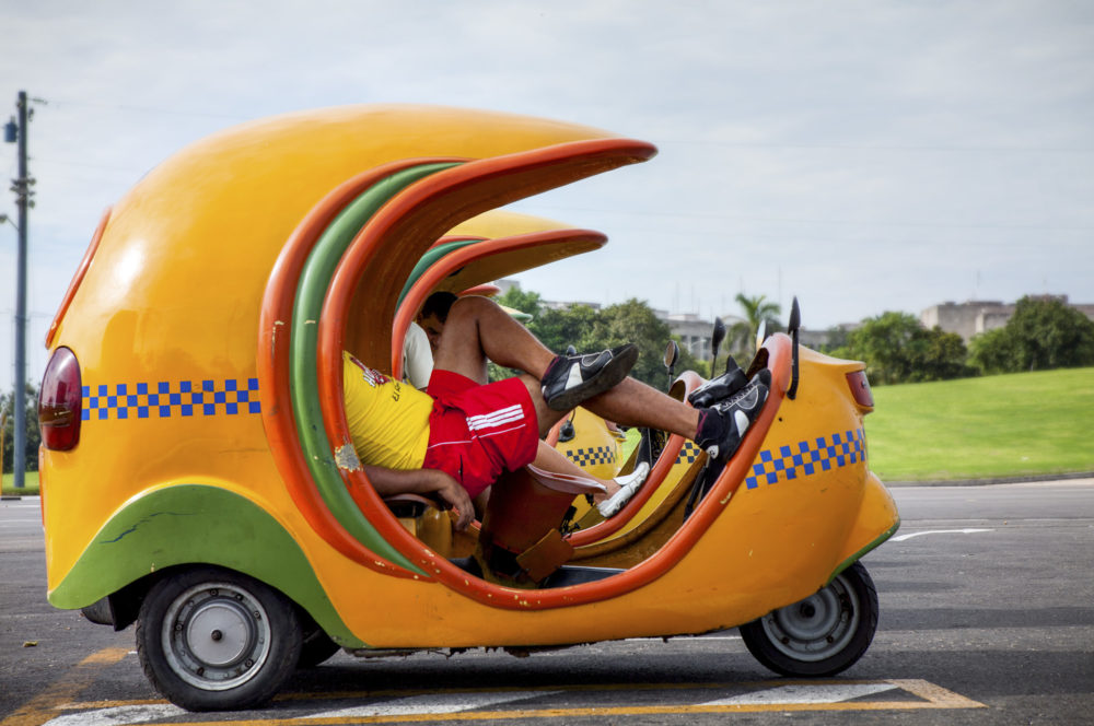 The famous Coco taxi. Driver relaxin while wating for the next ride.