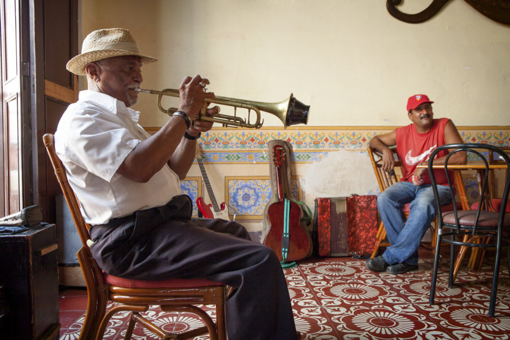 Man playing the trompet in a bar in Plaza Mayor in Trinidad, Cuba